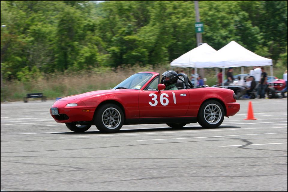Red convertible sports car with number 361 on door, side view