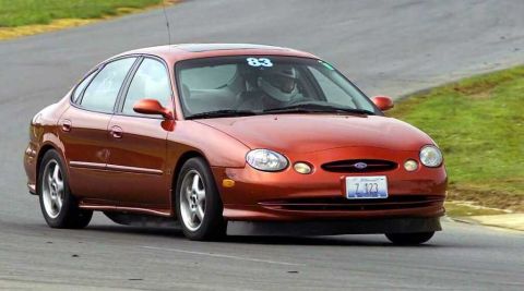 1997 Ford Taurus - A copper/orange Ford Taurus sedan turns through a corner on a road course with an Illinois plate reading 'Z 123', competition number 83 in…