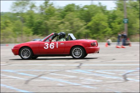 2001 Mercury Grand Marquis - A red convertible sports car with the number 361 on its door races on a track.