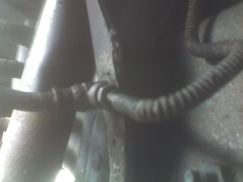 1991 Ford Bronco - A close-up view of brake lines and suspension parts, showing signs of rust and wear.
