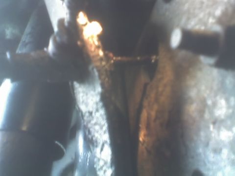 1991 Ford Bronco - Detail of a vehicle's brake system, likely showing wear and tear on the caliper and rotor.