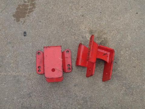 1996 Ford F-150 - Two red metal brackets are shown on a concrete surface.