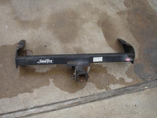 Trailer hitch with 'RAW-TITE' logo on concrete