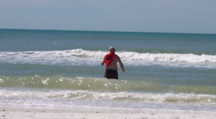 guy in water with red cloth around neck