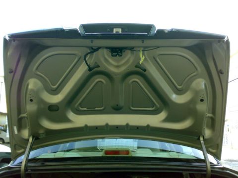 2007 Mercury Grand Marquis - The interior of the trunk of a 2007 Mercury Grand Marquis, showing the beige metallic paintwork.