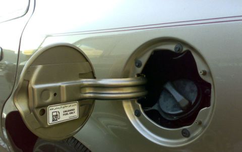 2007 Mercury Grand Marquis - The fuel door and cap of a vehicle are shown, with a sticker indicating unleaded fuel is required.