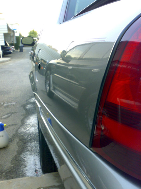 2007 Mercury Grand Marquis - The shiny paint reflects another vehicle, obscuring details of the car in the foreground.