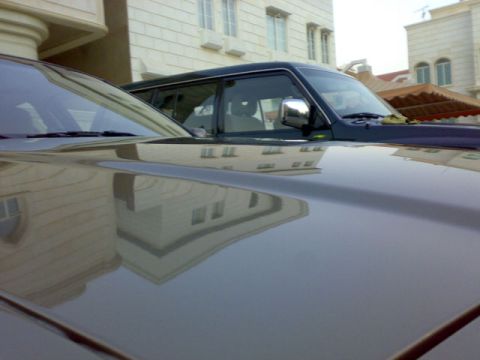2007 Mercury Grand Marquis - The reflection of buildings is visible on the hood of the car in the foreground.