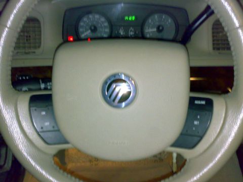 2007 Mercury Grand Marquis - The interior of a 2007 Mercury Grand Marquis, the steering wheel and instrument cluster with a digital display.
