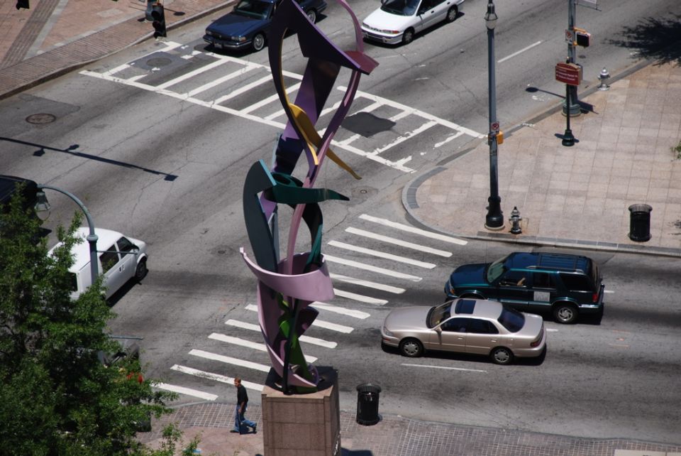 Abstract sculpture at intersection with cars and crosswalks