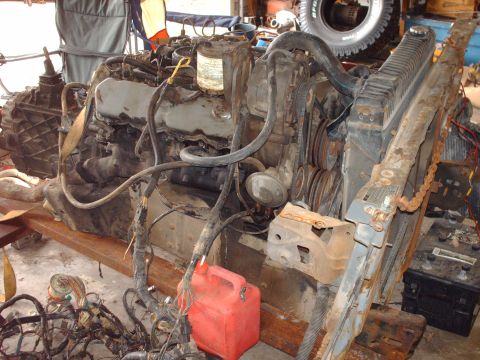 1982 Ford Bronco - Engine and transmission assembly with associated parts, including a radiator and battery.