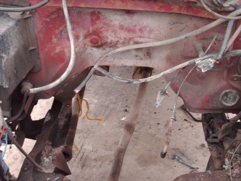 1982 Ford Bronco - Close-up view of a rusty engine bay with exposed wiring and metal components.