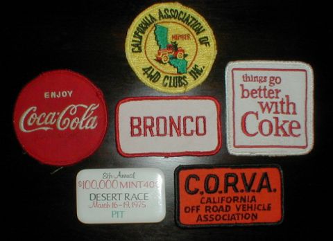 1996 Ford Bronco - A collection of embroidered patches includes Coca-Cola, Bronco, CORVA, and California 4WD Club memorabilia.