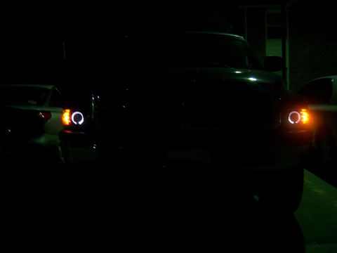 2001 Dodge 1500 - A 2001 Dodge 1500's front end is visible at night, illuminated halo headlights and turn signals.