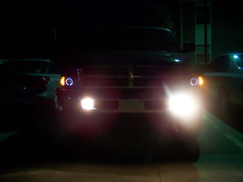 2001 Dodge 1500 - Front view of a 2001 Dodge 1500 pickup truck with illuminated halo headlights and bright low beams.