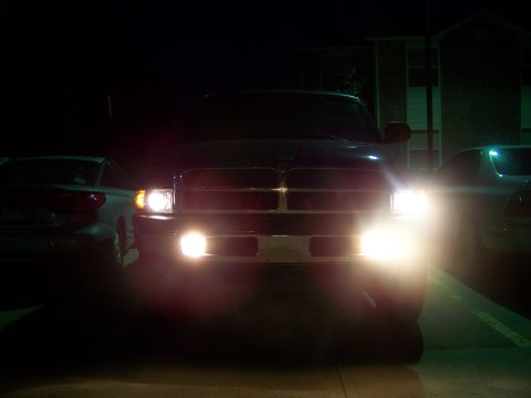 2001 Dodge 1500 - The front of a 2001 Dodge 1500 pickup truck is illuminated by its headlights at night.