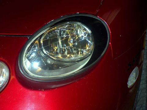1997 Ford Taurus - Close-up of the driver side headlight assembly on a 1997 Ford Taurus.