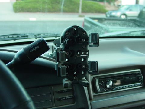 1994 Ford Bronco - Interior view showing a phone mount and aftermarket radio, with other vehicles seen through the windshield.