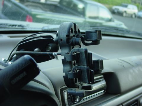 1994 Ford Bronco - Interior view of a dashboard with a phone mount and an Olympus camera grip attached.