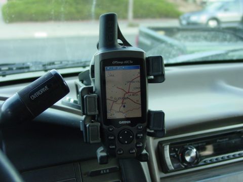 1994 Ford Bronco - A Garmin GPS unit is mounted on the dashboard next to an overdrive lever inside a vehicle.