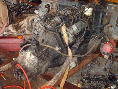 1982 Ford Bronco - Engine and transmission assembly, likely from a truck or SUV, is shown with various hoses and wiring attached.