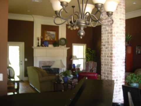 1995 Ford Bronco - A living room scene with a fireplace, chandelier, and brick column is visible.