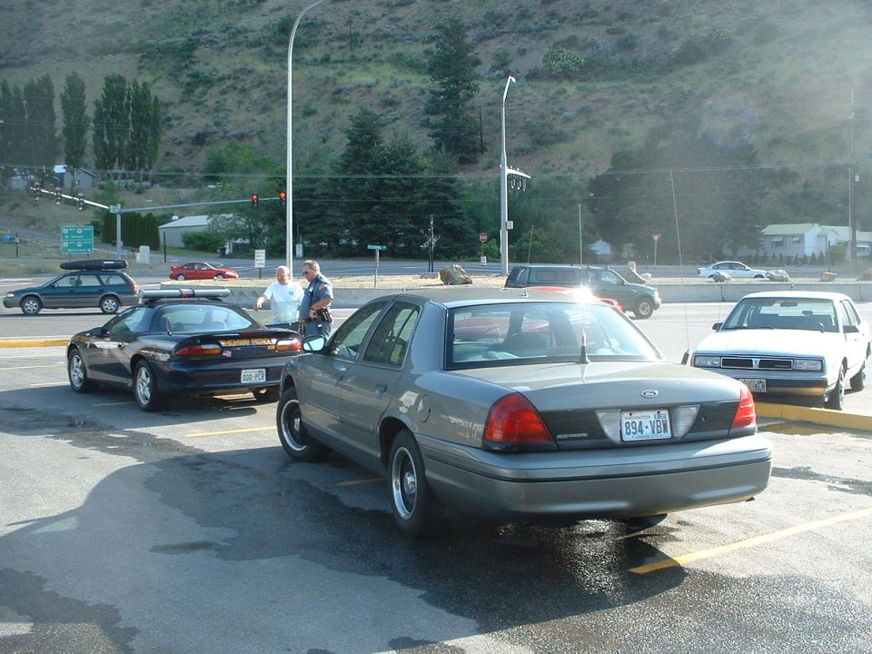 2000 Ford Crown Victoria police car parked, rear view. License plate 894-VBW