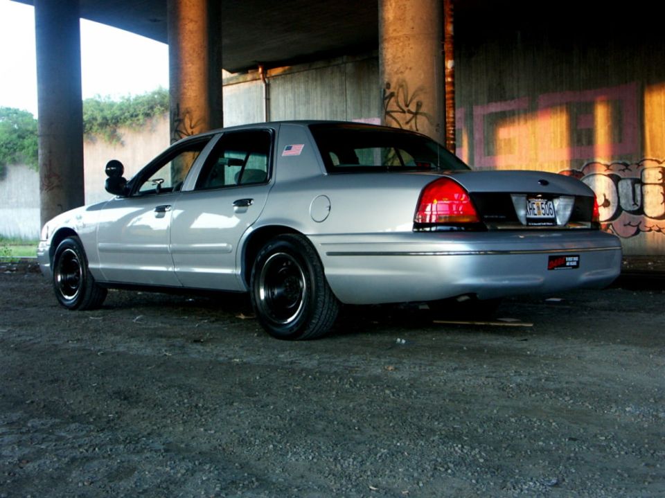 Silver 1998 Ford Crown Victoria, rear quarter view. Black wheels