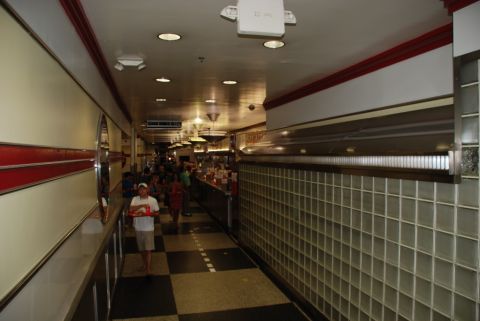 1996 Ford Bronco - A long diner interior with a checkered floor and people walking past a counter.