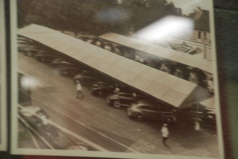 1996 Ford Bronco - A parking lot scene with multiple vehicles sheltered under a large canopy structure.