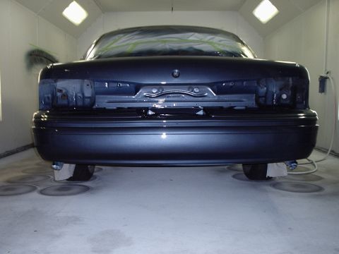 1996 Ford Crown Victoria - Rear view of a 1996 Ford Crown Victoria undergoing refinishing in a paint booth.