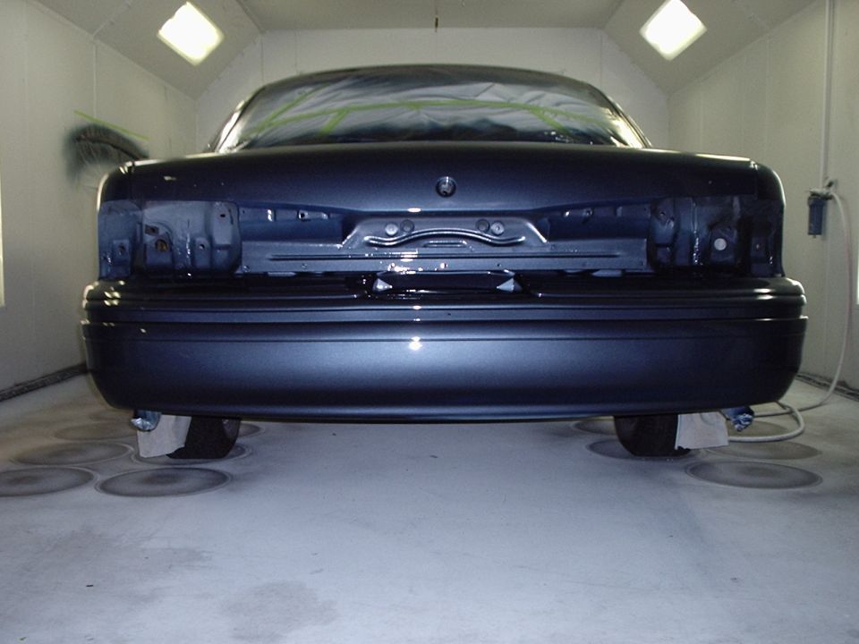 1996 Ford Crown Victoria rear in paint booth, taillights removed, bumper intact