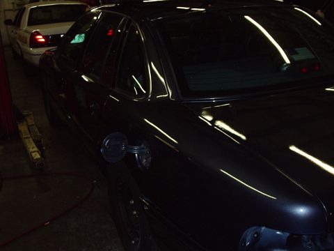 1996 Ford Crown Victoria - Dark 1996 Ford Crown Victoria in garage with gas cap open; white car behind it.