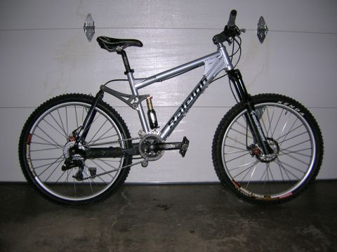 1997 Ford Probe - A silver Raleigh mountain bike is shown in a garage, with a visible shock absorber and disc brakes.