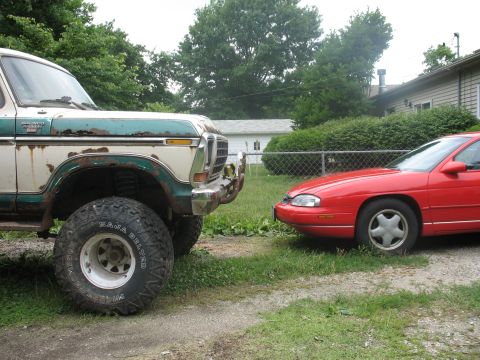 1978 Ford Bronco - A 1978 Ford Bronco is parked next to a red Chevrolet Monte Carlo in a residential driveway.