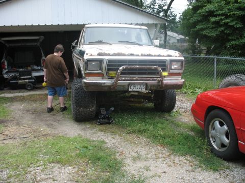 1978 Ford Bronco - A lifted 1979 Ford F-Series pickup truck sits in a driveway, showing off its large tires and bull bar.