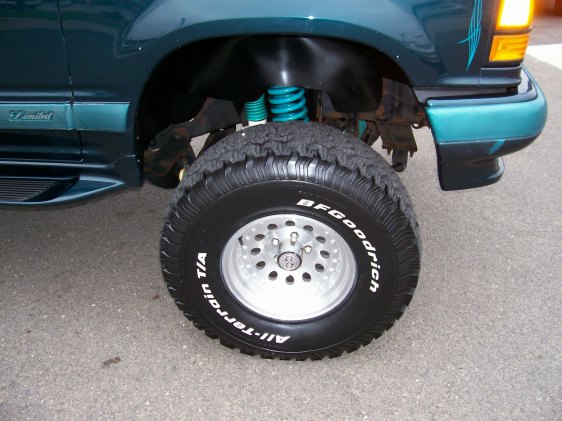 Green 1994 Ford Explorer front wheel and fender with "Limited" badge