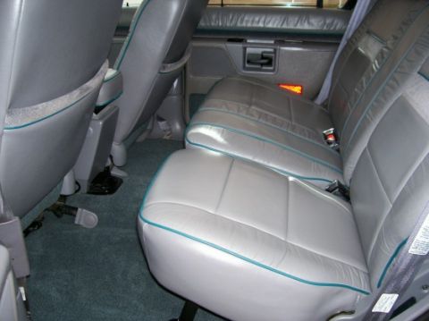 1994 Ford Explorer - Rear interior view of a 1994 Ford Explorer, showing the leather seats and door panel.