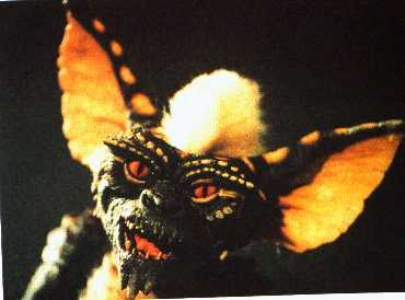 1991 Ford Bronco - Close-up of a Gremlin creature's face against a dark background.