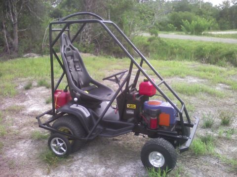 2001 Ford F-150 - A black go-kart with a roll cage and racing seat sits outdoors on a grassy area.