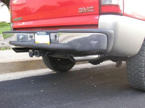 1994 Ford Probe - Red GMC Sierra pickup truck's rear bumper, trailer hitch, and exhaust pipe are visible in this photo.