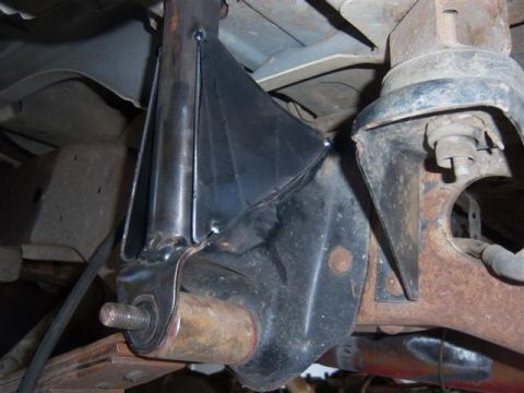 1995 Ford Bronco - Close-up of a custom-welded rollcage mount attached to the vehicle's suspension system.