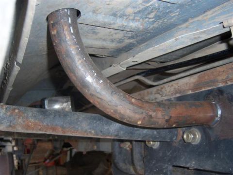1995 Ford Bronco - Custom exhaust pipe modification visible on the underside of a vehicle.