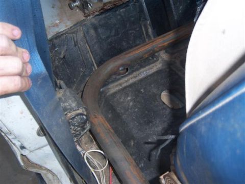 1995 Ford Bronco - Close-up view of a rollcage and seatbelt inside a vehicle, with visible wiring.