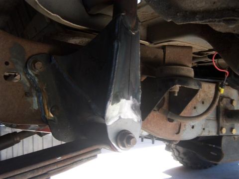 1995 Ford Bronco - Close-up of a modified suspension component on a vehicle's undercarriage.
