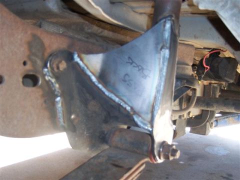 1995 Ford Bronco - A custom metal bracket is welded onto the vehicle's frame, showing signs of modification and handwritten markings.