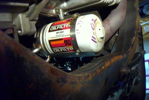 1997 Ford Taurus - Close-up of a K&N HP-3001 oil filter attached to the vehicle's frame.
