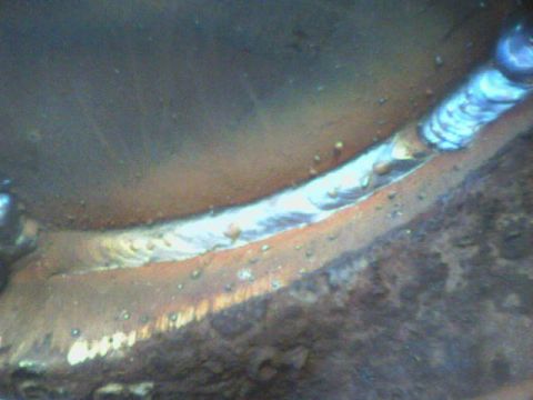 1991 Ford Bronco - This image shows a close-up view of a welded metal joint, highlighting the texture and imperfections of the weld.