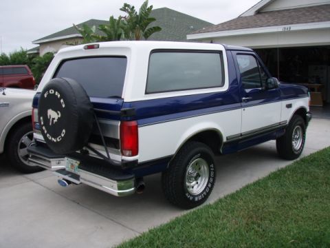 1996 Ford Bronco - This two-tone blue and white Ford Bronco features a spare tire mounted on the rear tailgate.