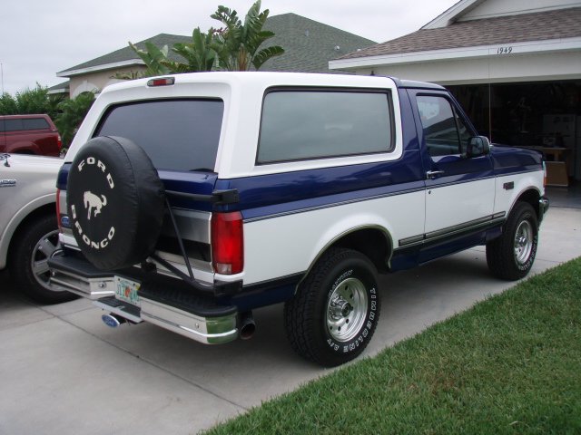 Blue and white Ford Bronco rear view with spare tire. 1996 Ford Bronco